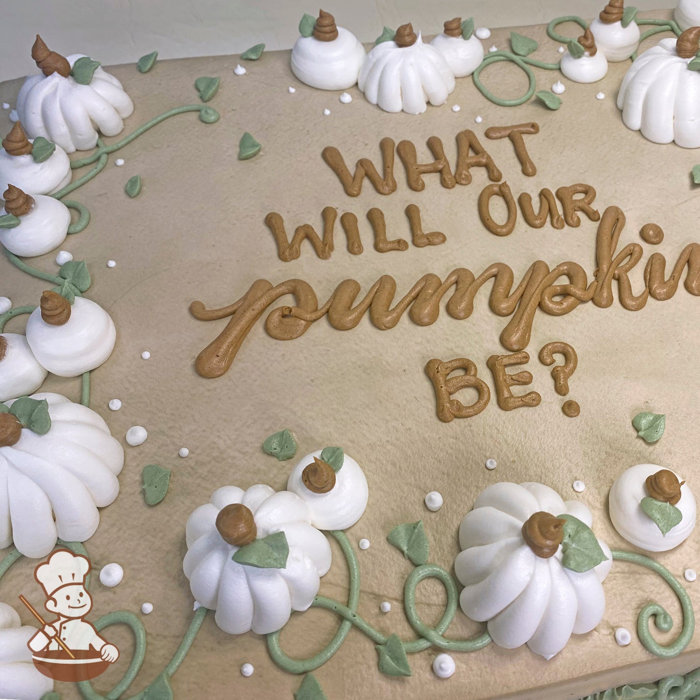 Sheet cake with buttercream pumpkins, green vines, and white dots. White pumpkins with brown stems and green leaves decorate the surface.