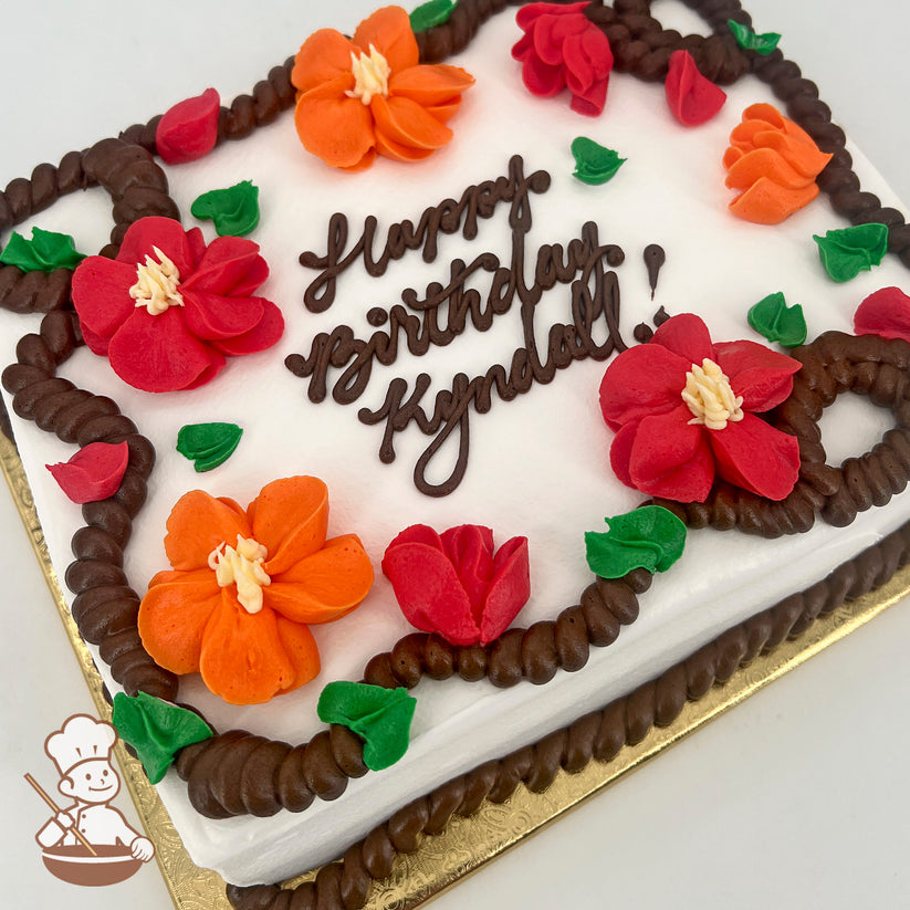 Sheet cake with white frosting, decorated with orange and red buttercream blossoms, green leaves, and brown rope trim along the edges.