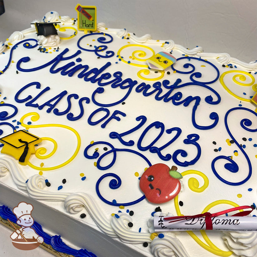 Sheet cake with white frosting, blue and yellow swirls, confetti, a plastic yellow graduation cap, a red apple, and a diploma decoration.