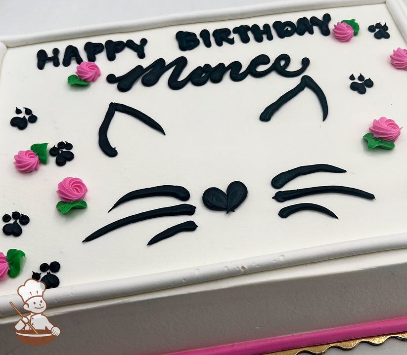 White sheet cake with black buttercream cat face design, including ears, whiskers, and a heart-shaped nose. Decorated with pink buttercream roses and black paw prints.