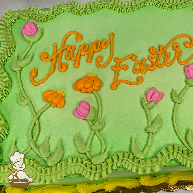 Sheet cake with green frosting, orange and pink buttercream flowers, green stems and leaves, and ruffled green borders.