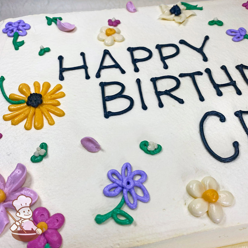 A white sheet cake with buttercream decorations of colorful flowers, including daisies, black-eyed Susan's, and purple and pink blossoms.