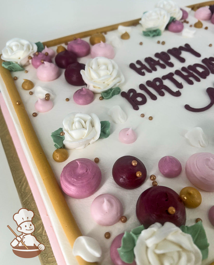 A sheet cake with white frosting, decorated with white buttercream roses, pink and burgundy dollops, gold pearl beads, and a gold border.