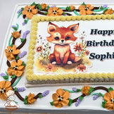 Sheet cake with buttercream decorations featuring orange blossoms, purple lavender sprigs, and green leaves on brown vines. Yellow piped border surrounds a printed photo layer.