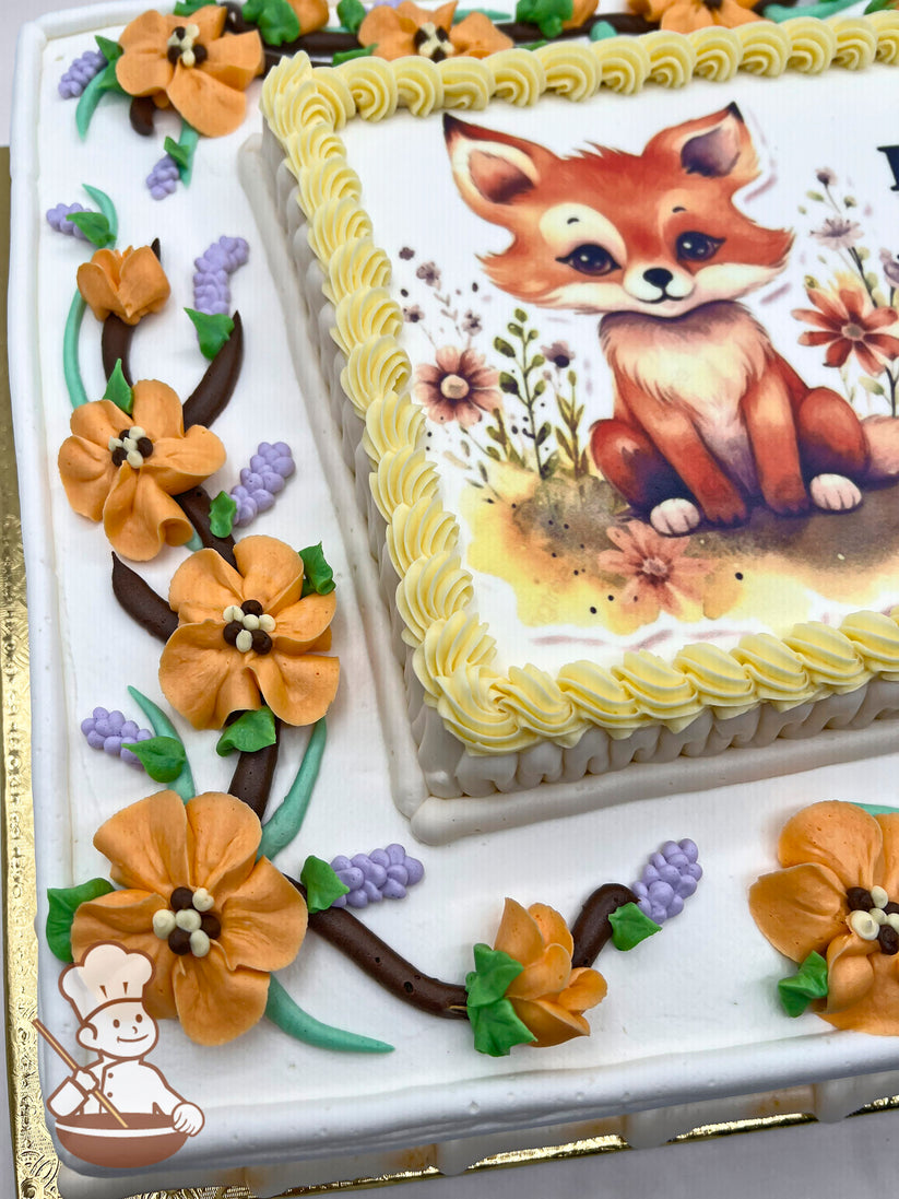 Sheet cake with buttercream decorations featuring orange blossoms, purple lavender sprigs, and green leaves on brown vines. Yellow piped border surrounds a printed photo layer.