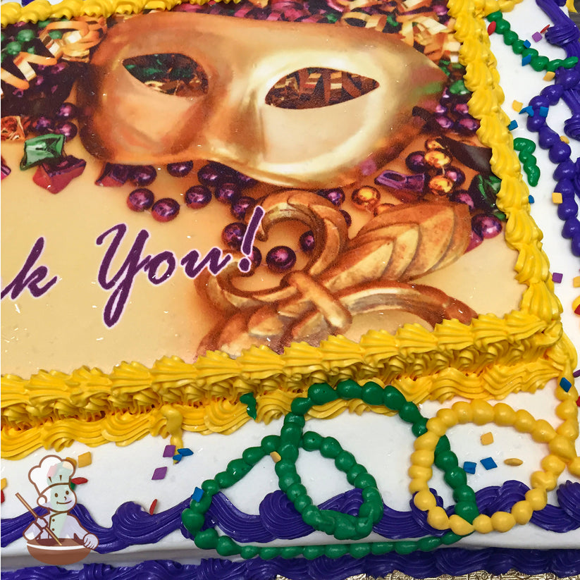 Sheet cake with yellow and purple buttercream borders, green, yellow, and purple buttercream bead necklaces, and scattered confetti decorations.