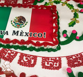 Sheet cake with red buttercream borders, green and pink cactus decorations, yellow and green vine accents, and red papel picado banner designs.