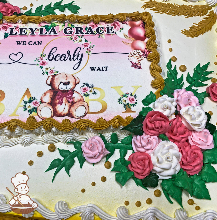 Sheet cake with pink and white buttercream roses, green leaves, golden accents, and a decorative border.