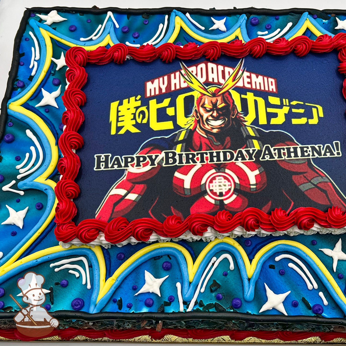 Sheet cake with a printed design, bordered by red buttercream swirls. Blue background with yellow piping, star accents, and dots.