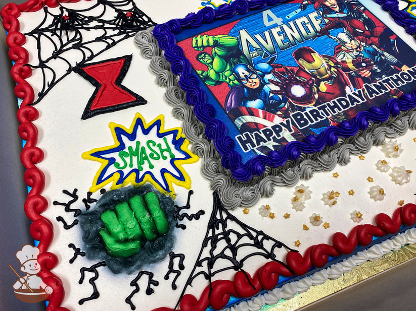 Sheet cake with Avengers-themed buttercream decorations, including spider webs, a red hourglass, yellow lightning bolts, a green Hulk fist, and "Smash" in a comic-style burst.