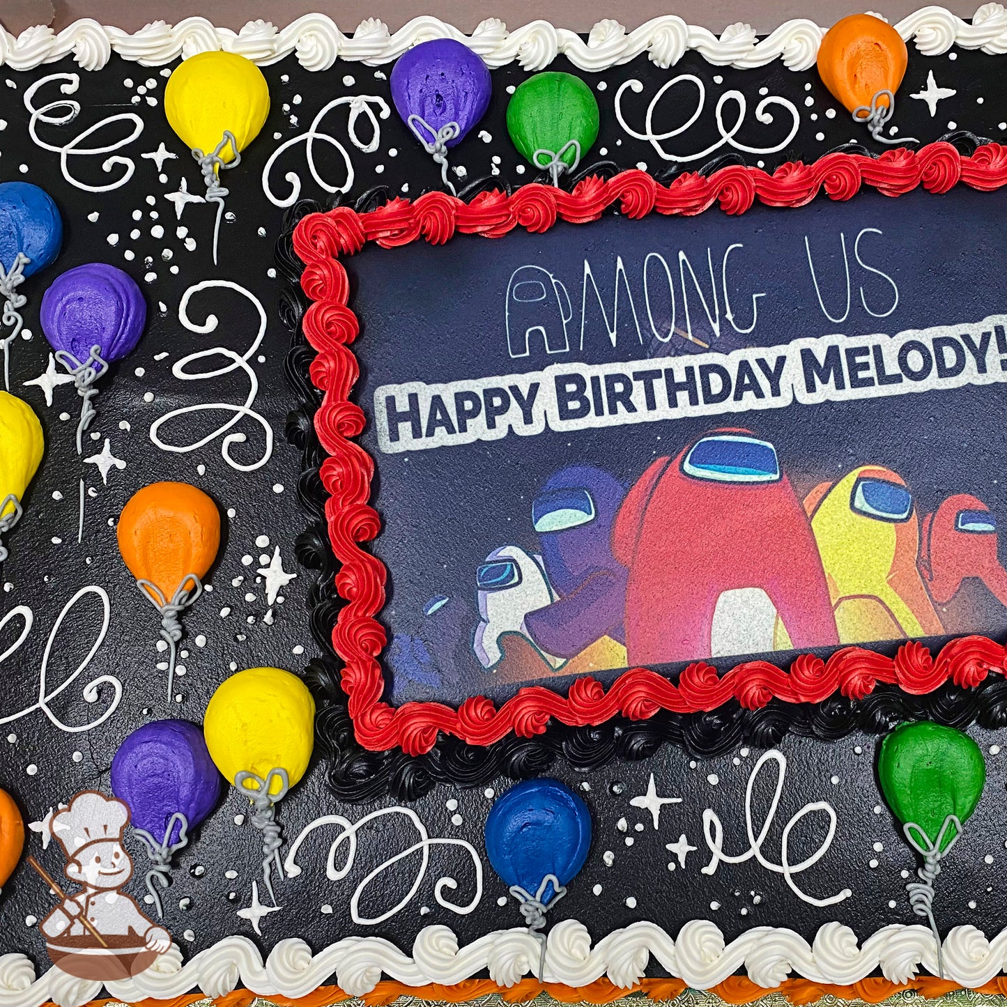 Sheet cake with colorful buttercream balloons, white swirls, and stars on a black background. Red border surrounds a central printed image.