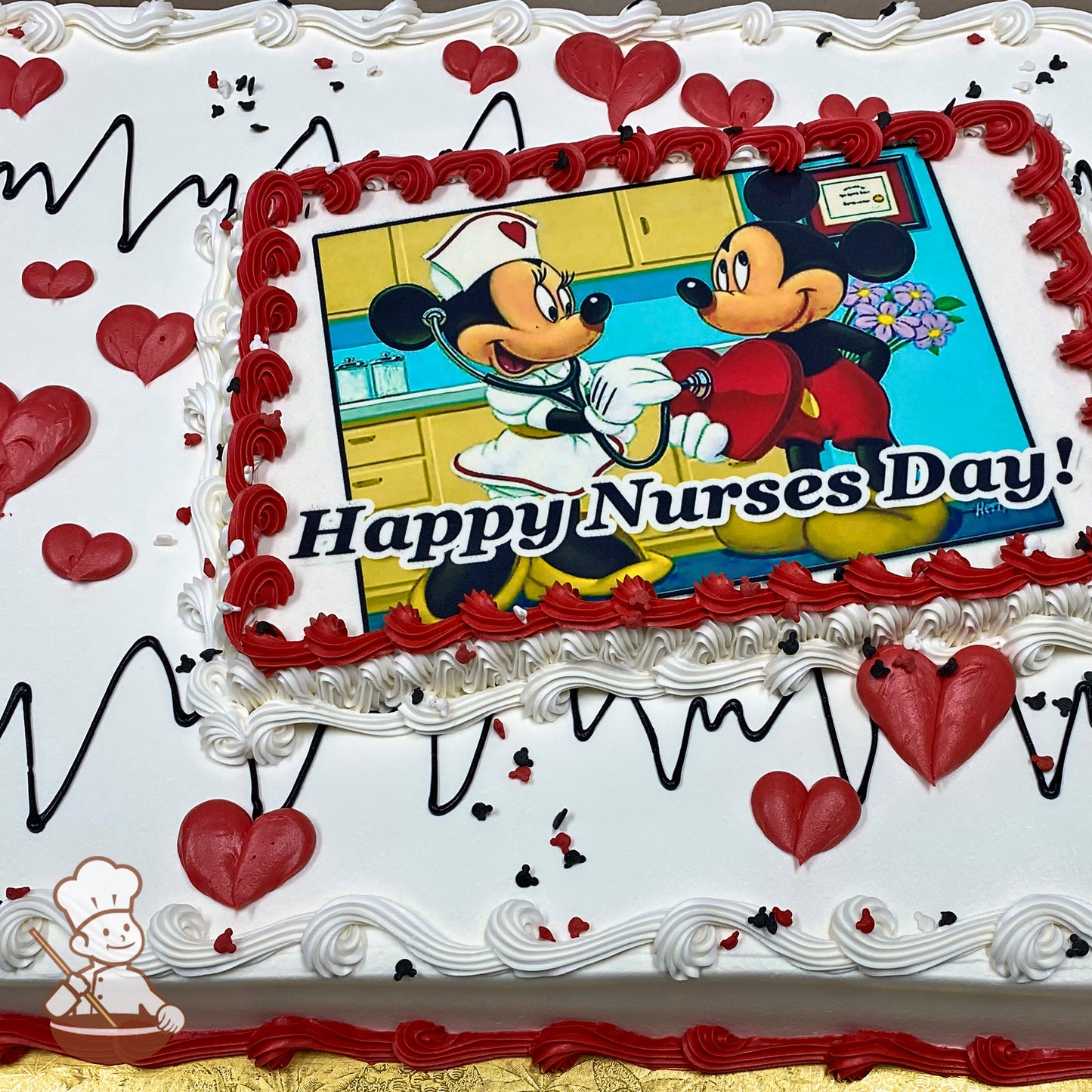 Sheet cake with white frosting, red heart decorations, black EKG line designs, and a red buttercream border around a printed image.