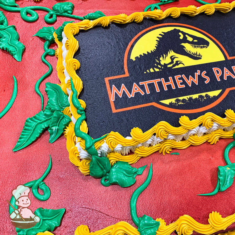 Sheet cake with green buttercream jungle vines, yellow and white piped borders around a central printed image.