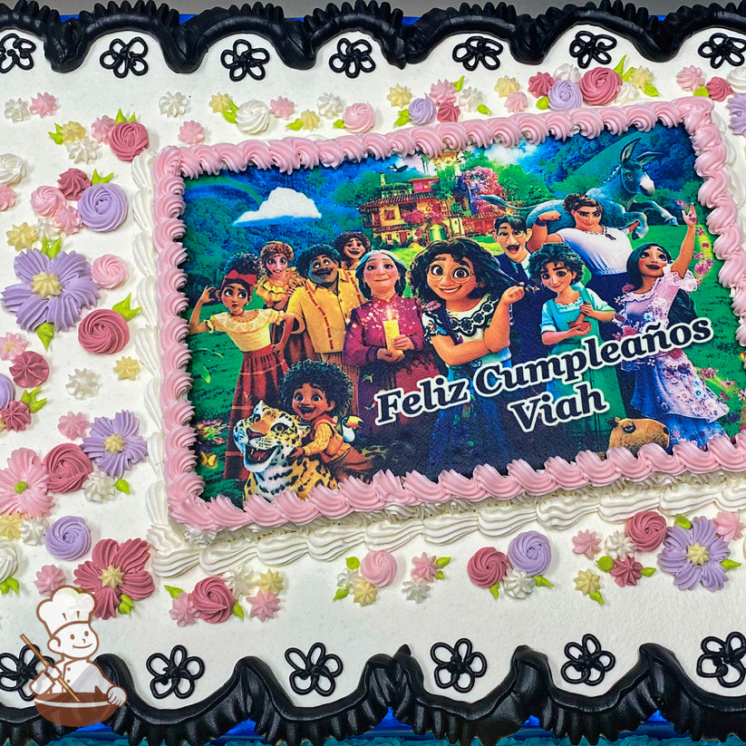Sheet cake with a pink piped border around a printed image, surrounded by pastel buttercream flowers in purple, pink, and yellow, and a black lace-like border.