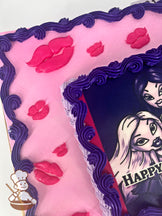 Sheet cake with pink icing, decorated with pink lips and purple swirl trims.
