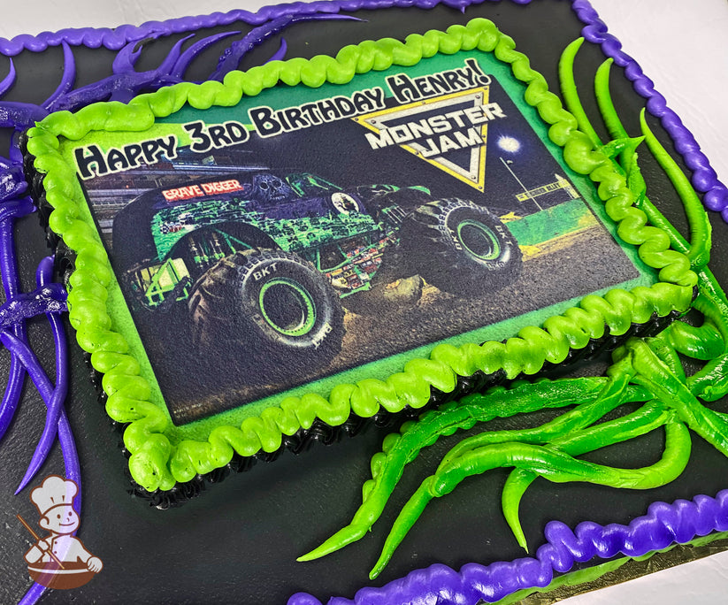 Sheet cake with black base, green and purple piped decorations resembling tentacles, and a printed image framed by green frosting.