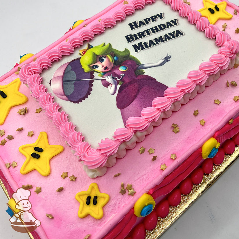 Pink sheet cake with a printed photo layer, pink buttercream border, yellow star decorations, and gold star sprinkles.