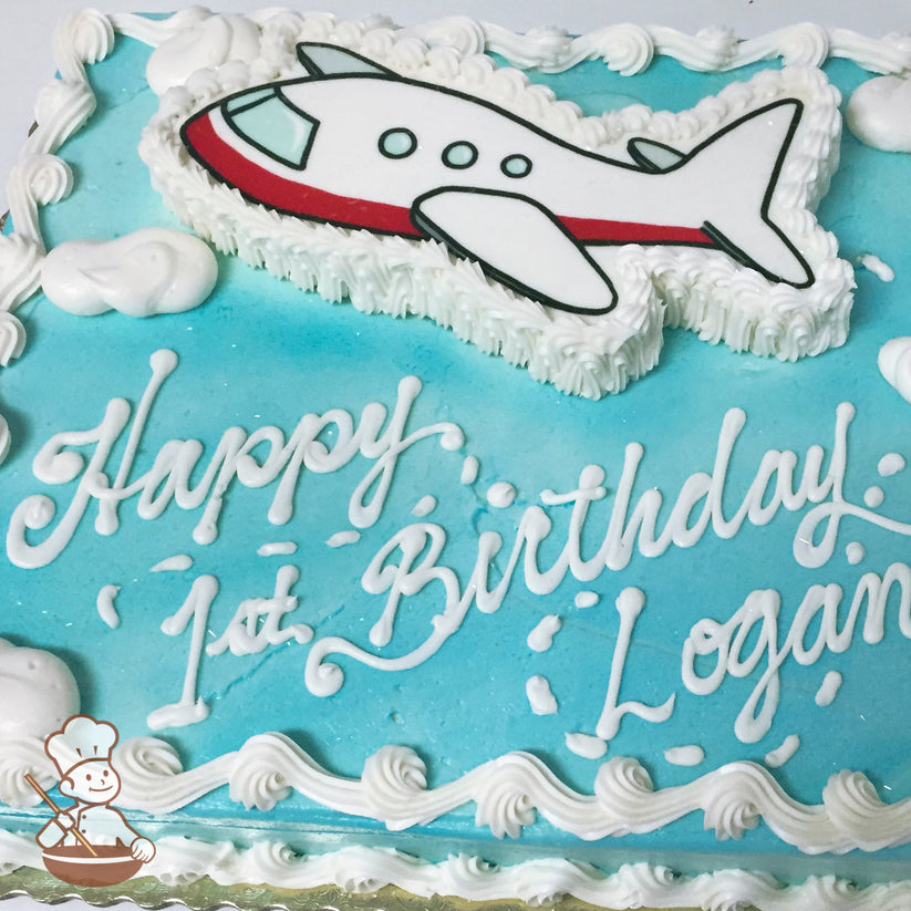 Sheet cake with light blue frosting, white piped borders, cloud decorations, and a white airplane cutout with red and black accents.