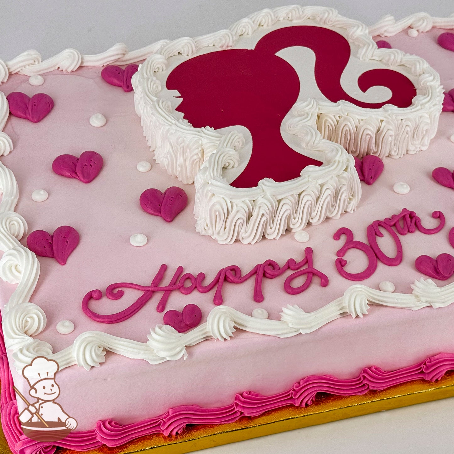 Sheet cake with a Barbie silhouette cutout outlined in white buttercream, surrounded by pink buttercream hearts, white dots, and pink and white borders.