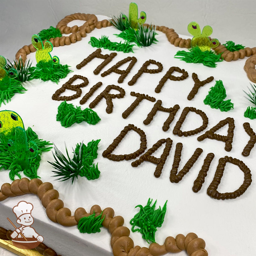 Sheet cake with white frosting, decorated with plastic cactus toppers, green buttercream bushes, and brown buttercream rope trim.