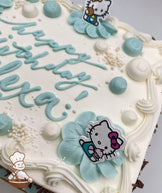 Sheet cake with buttercream petals, blue and white dollops, pearl sprinkles, and plastic Hello Kitty toys with swirl trims.