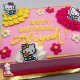 Pink sheet cake with buttercream decorations, featuring plastic Hello Kitty ring toppers, yellow, white and pink ruffles, and daisies.