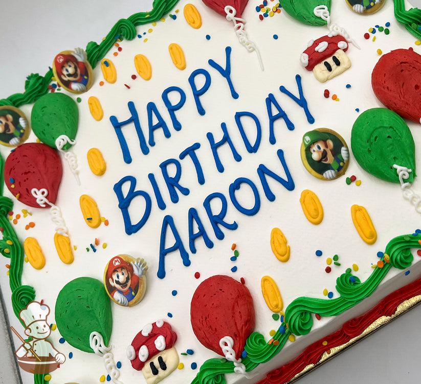 Sheet cake with buttercream decorations, featuring red and green balloons, gold coins, Super Mario and Luigi plastic rings, and a Super Mushroom design.