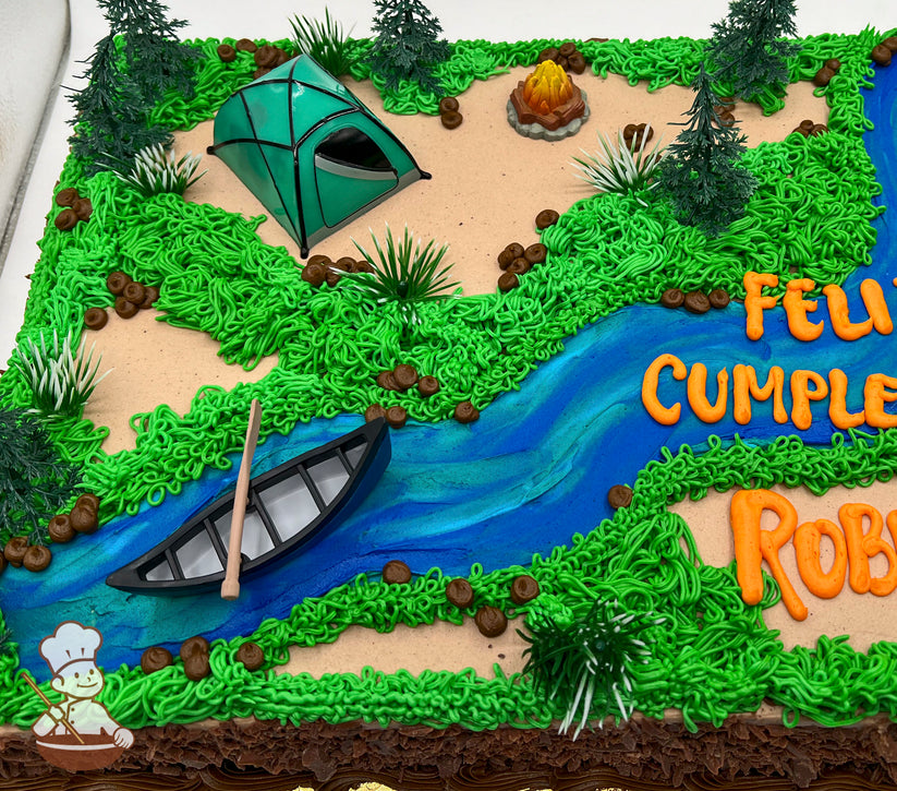 Sheet cake decorated with a camping scene, featuring a plastic toy tent, canoe on a blue river, buttercream grass, trees, and a fire pit.