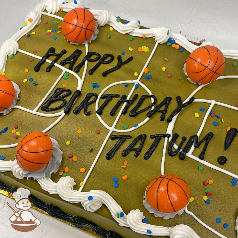 Sheet cake decorated as a basketball court with white buttercream lines, plastic basketball toys, colorful confetti sprinkles, and white frosting borders.
