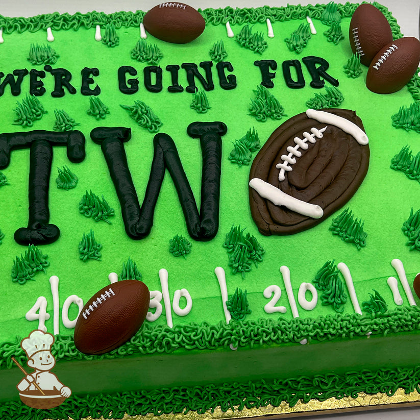 Green sheet cake with buttercream grass, plastic football toys, and a large hand piped buttercream football decoration.