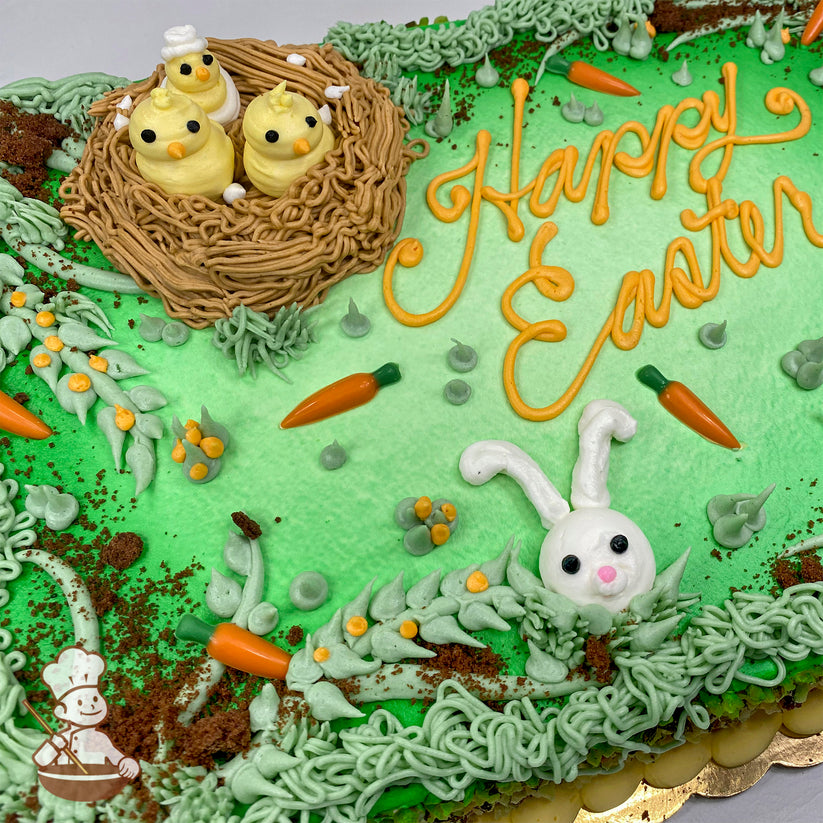 Sheet cake with green frosting, a buttercream nest holding three yellow chicks, a white bunny face, orange chocolate carrots, and cake crumb "dirt."