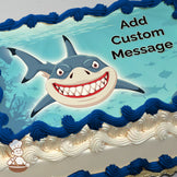 A cartoon shark with a wide, toothy grin swims in an underwater scene with fish silhouettes and coral in the background, printed on a sheet cake.