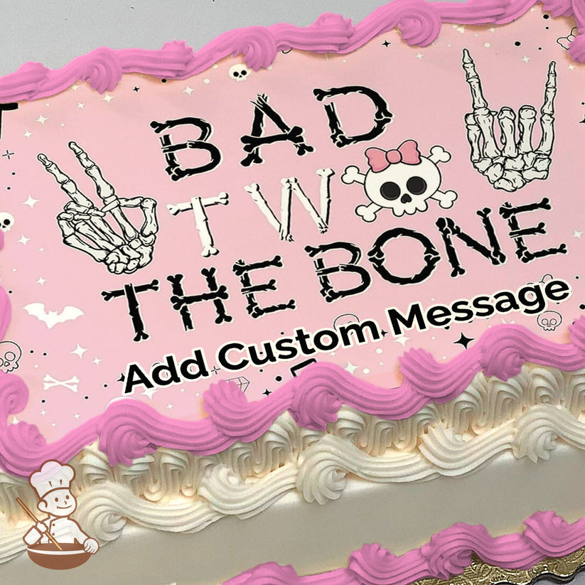 Pink background with "Bad to the Bone" text in a bone-like font, skeleton hand gestures, and a skull with a pink bow. Printed on a photo sheet cake.