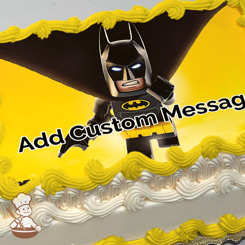 Lego Batman in a black suit with a yellow utility belt and glowing eyes, standing against a bright yellow gradient background. Printed on a sheet cake.