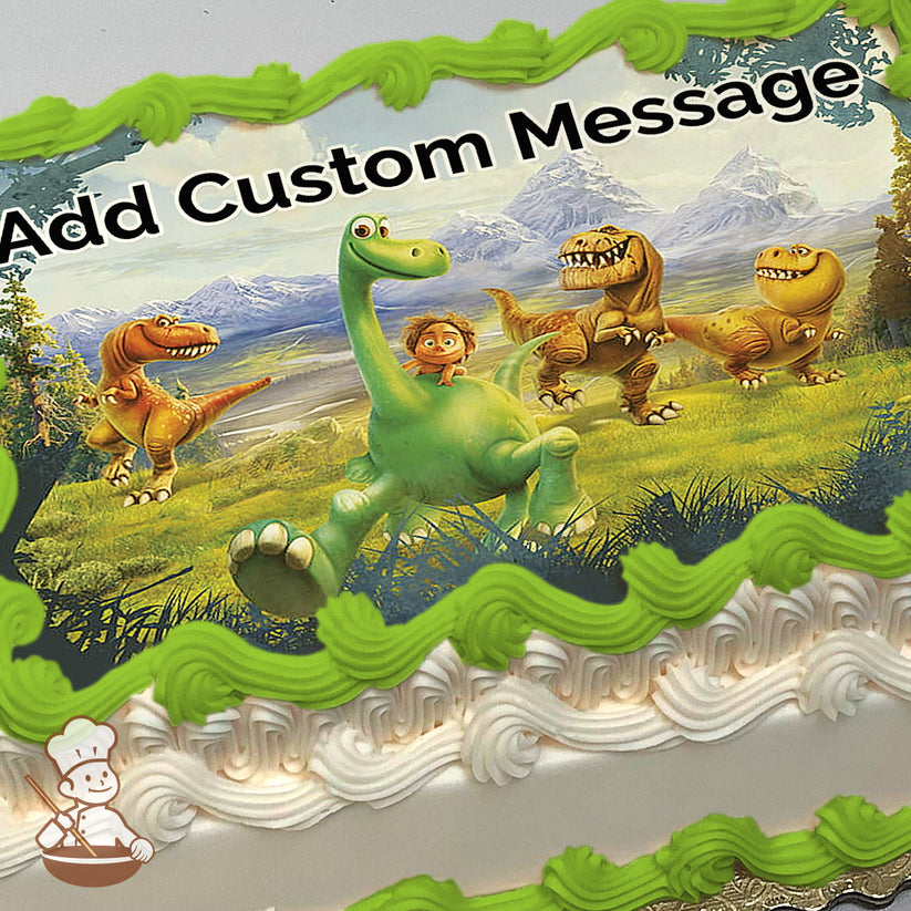 A cartoon image of a green dinosaur with a boy on its back, surrounded by three other dinosaurs in a grassy field with mountains in the background, printed on a photo sheet cake.