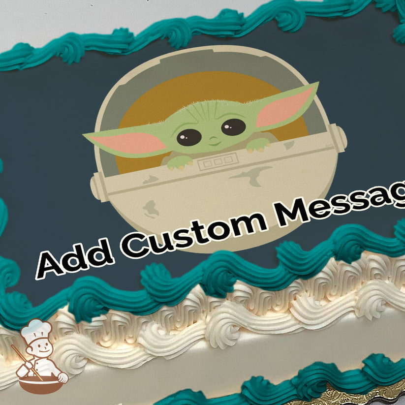 Cartoon illustration of Grogu peeking out of a beige pod with an orange background, set against a solid dark blue backdrop, printed on a sheet cake.