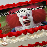 A close-up of a scary clown with red hair, a white face, sharp yellow teeth, and a red nose, set against a blurry outdoor background. Printed on a photo sheet cake.