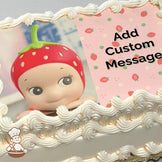A cartoon character with a strawberry-themed hat smiles with a light blue tiled background. The right side has a pink strawberry pattern. Printed on a sheet cake.