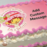 Illustration of Strawberry Shortcake, a cartoon character with red hair, a pink hat, and striped shirt, on a pink background. Printed on a sheet cake.