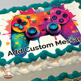 A colorful illustration of a video game controller with vibrant splashes of orange, pink, blue, and yellow on a white background, printed on a sheet cake.
