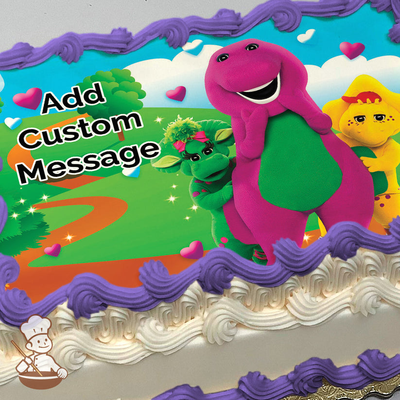 Cartoon image of Barney the purple dinosaur, Baby Bop, and BJ smiling in a sunny park with trees, a winding path, and colorful hearts. Printed on a sheet cake.