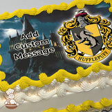 Hogwarts castle at night on a rocky hill with a cloudy sky, next to the Hufflepuff crest featuring a badger on a yellow and black shield. Printed on a sheet cake.