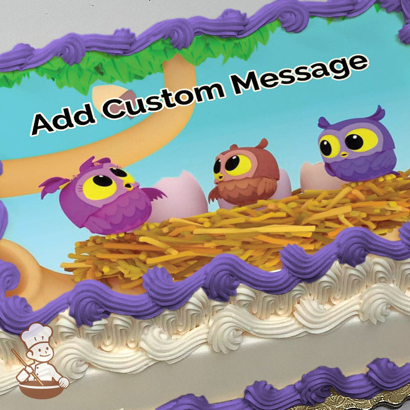 Three cartoon owls, purple, brown, and blue, sit in a nest with eggs on a tree branch against a bright blue sky. Printed on a sheet cake.