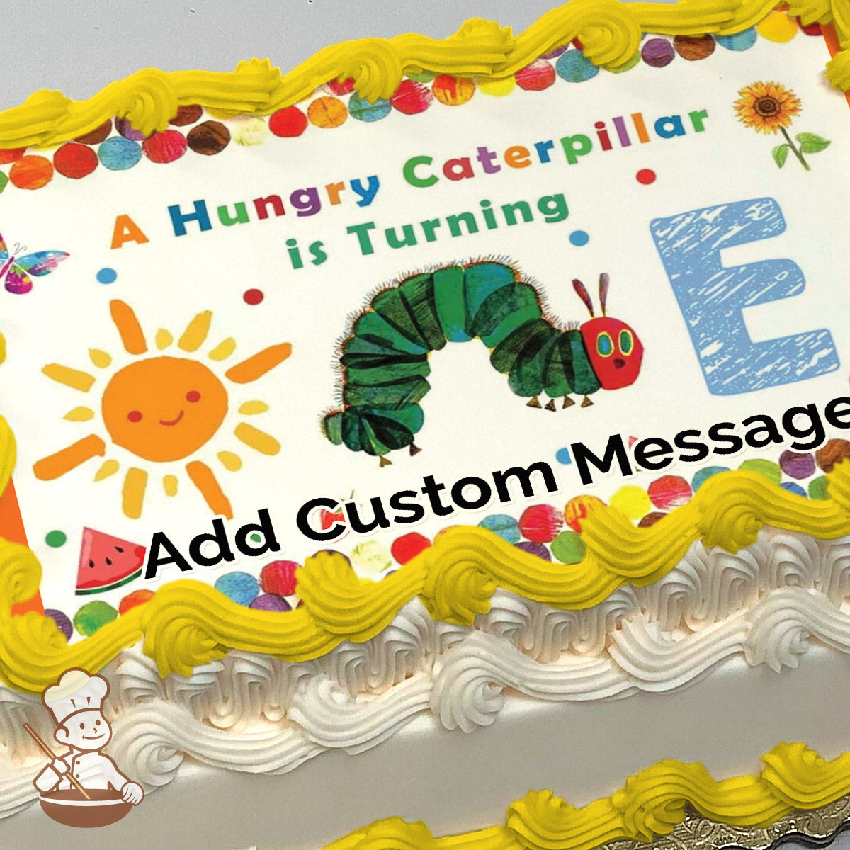 Illustration of a green caterpillar with a red head, a smiling sun, a butterfly, and colorful dots on a white background, printed on a sheet cake.