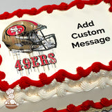 A printed image of a San Francisco 49ers football helmet with the text "49ERS" in bold red letters beneath it, on a sheet cake.