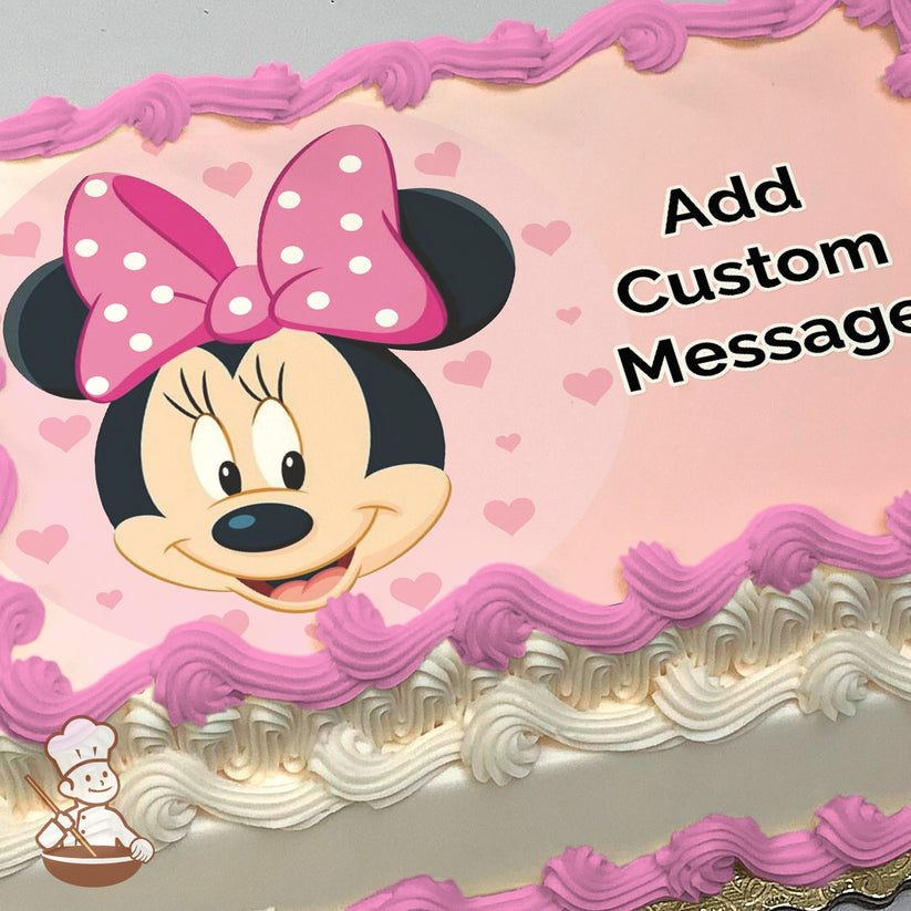 Cartoon image of Minnie Mouse smiling, wearing a pink polka-dot bow, surrounded by small pink hearts on a light pink background, printed on a sheet cake.