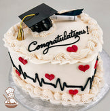 Heart-shaped white cake with piped frosting borders, red heart decorations, a black heartbeat line, and a "Congratulations!" message. Topped with a graduation cap and diploma.