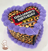 Heart-shaped cake with a leopard print design, topped with purple frosting borders. The text on top reads "Gilliana's Birthday, Season 26, Uncensored."