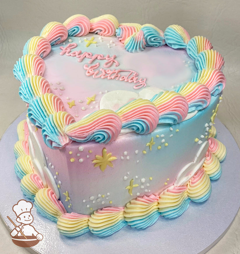 Heart-shaped pastel cake with pink, blue, and yellow swirled frosting borders. Decorated with stars, dots, and "happy birthday" written in pink icing.