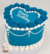 Heart-shaped cake with blue frosting, white piped borders, and "Happy Birthday" written on top. Decorated with white icing swags and dots.